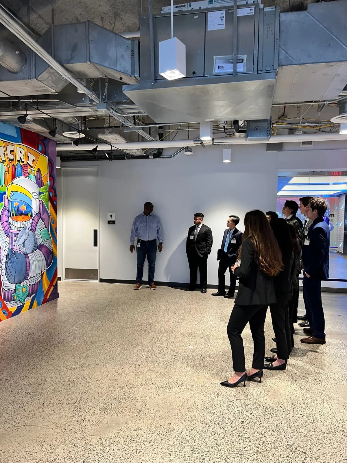 Members walking through a firm office on the TASK Trip.