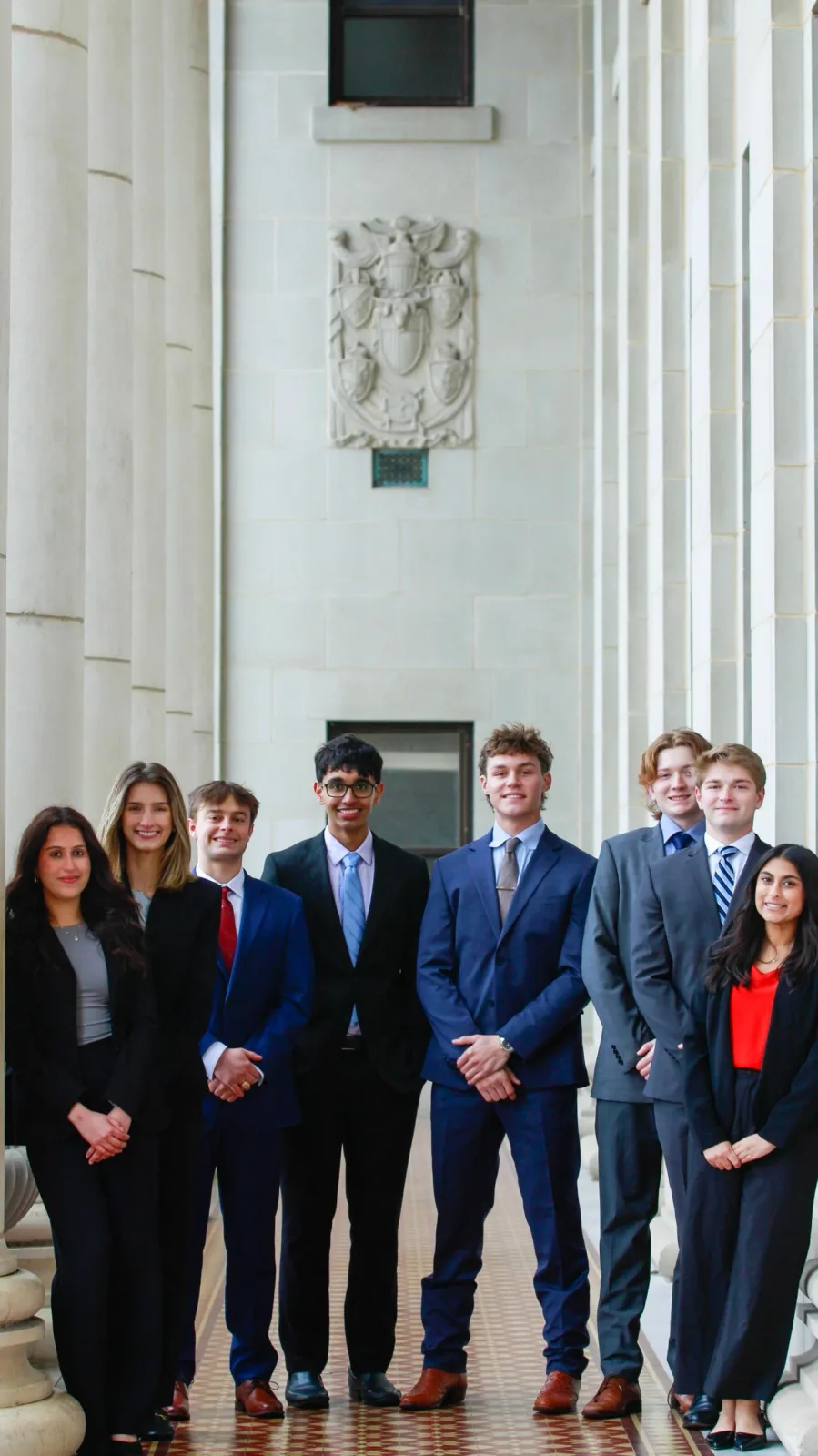 Six TASK members in business attire on the steps of the Memorial Student Center.