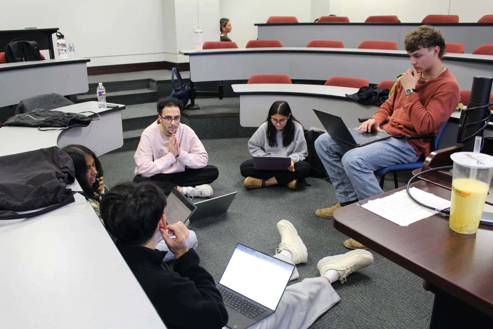 A TASK project team working through a session on laptops.